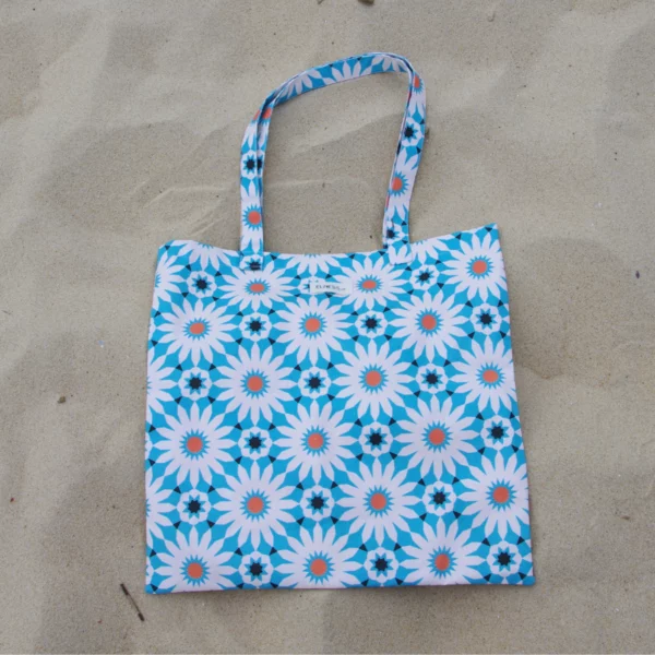 Sac tote bag ou sac banane XL Elness.co avec son motif Azulejos tout droit sorti du Portugal et sa couleur bleu turquoise en 100% coton certifié oeko tex. Il nous embarque directement sur la côté à la plage, c'est la pièce summer 2024. Il est fabriqué en France plus précisément en Charente près d'Angoulême.