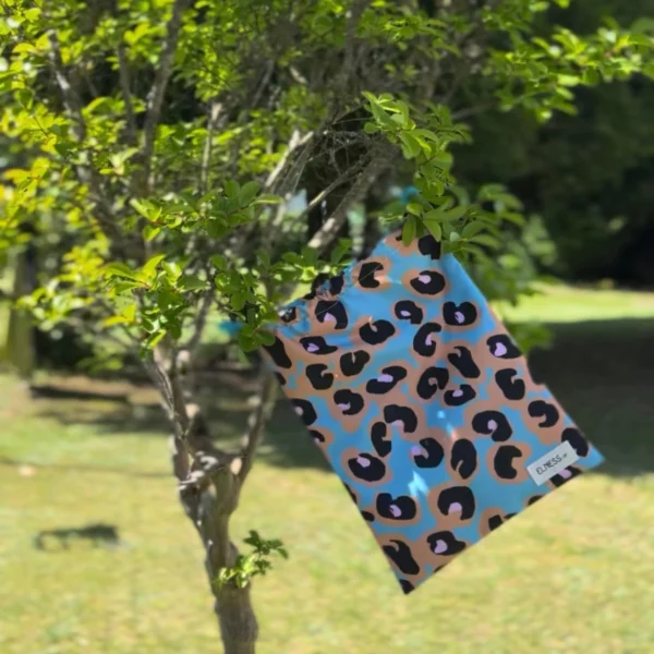 Pochette imperméable et écoresponsable, confectionnée à partir de chutes de tissus et fermée par des liens en coton recyclé, idéale pour transporter maillot mouillé, produits de beauté ou linge sale en voyage.