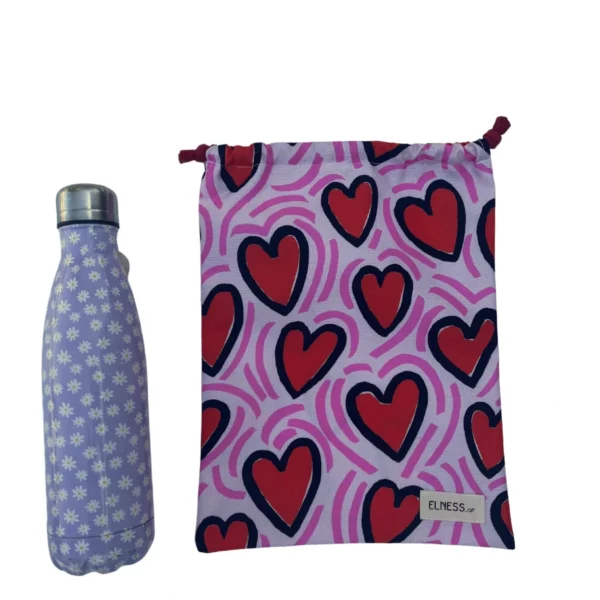 Pochette imperméable et écoresponsable, confectionnée à partir de chutes de tissus et fermée par des liens en coton recyclé, idéale pour transporter maillot mouillé, produits de beauté ou linge sale en voyage.